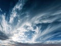 Dramatic sky filled with swirling wispy clouds creating a dynamic and textured atmosphere during a serene sunset over the horizon Royalty Free Stock Photo