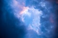 Dramatic sky full of dark clouds in bad weather before a big storm rain with a patch of light blue sky in center. Light Royalty Free Stock Photo