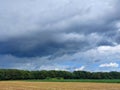 dramatic sky with gray clouds over green forest. Slovenia Royalty Free Stock Photo