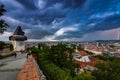 Dramatic sky and lightning storm over the city of Graz and the famous clock tower on Shlossberg hill, Graz, Styria region, Austria Royalty Free Stock Photo