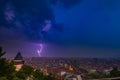 Dramatic sky and lightning storm over the city of Graz and the famous clock tower on Shlossberg hill, Graz, Styria region, Austria Royalty Free Stock Photo