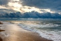 Dramatic sky on a morning seascape. Sunrise on a sandy beach.