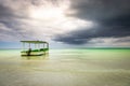 Dramatic sky over beach with motorboat, Negril Seven Mile Beach, Jamaica Royalty Free Stock Photo
