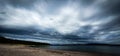 Dramatic sky over beautiful sandy beach and archipelago in Gulf of Bothnia. Storsand, High Coast in northern Sweden Royalty Free Stock Photo