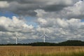 Dramatic sky over field and windmills Royalty Free Stock Photo