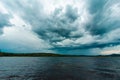 Dramatic sky over a lake close to Soderhamn and Hudiksvall in Sweden. Dark blue stormy clouds reflected in the dark water