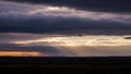 Dramatic sky over a landscape at sunset, featuring layers of Royalty Free Stock Photo