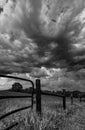 Dramatic sky over a pasture in black and white Royalty Free Stock Photo