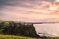 Dramatic sky over ruins of Dunluce Castle perched on the edge of cliff, Northern Ireland Royalty Free Stock Photo