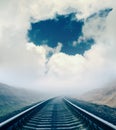 Dramatic sky and railroad in fog Royalty Free Stock Photo