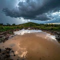 Dramatic Sky Reflection on a Muddy Rural Road Royalty Free Stock Photo