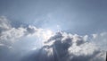 A dramatic sky scene where bright sunlight penetrates through thick clouds, creating a sunburst or crepuscular rays effect. Royalty Free Stock Photo