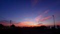 Dramatic sky with silhouette of street lamp and parking lot Royalty Free Stock Photo