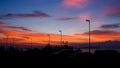 Dramatic sky with silhouette of street lamp pole and car park at port Royalty Free Stock Photo