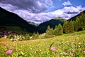 Dramatic sky after a storm under a dark blue brooding sky with alpine peaks in Berwang, Tirol