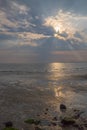 Dramatic sky with sun rays above Colwyn bay, North Wales. Dawn sunrise on the coast with a calm sea Royalty Free Stock Photo