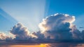 Dramatic sky with sun rays bursting through dark clouds at sunset casting orange and blue hues Keywords: sky, clouds Royalty Free Stock Photo