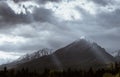 Dramatic sky with sunbeams breaking through heavy clouds over the Slavkovsky siit peak is the fourth highest mountain peak in