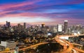 Dramatic sky after sunset of elevated highway with city office building background Royalty Free Stock Photo