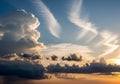 Dramatic sky at sunset features large cumulus clouds on the left, with bright white tops illuminated Royalty Free Stock Photo