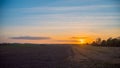 Dramatic sky during sunset over the field Royalty Free Stock Photo