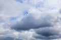 Dramatic sky with thick gray clouds and blue patches on overcast day Royalty Free Stock Photo