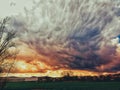 Dramatic sky with upcoming bad weather and black clouds as the sun goes through the clouds and creates the wonderfully colorful sk Royalty Free Stock Photo