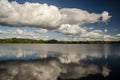 Dramatic sky with white clouds, reflection, lake and forest, Latvia Royalty Free Stock Photo