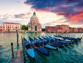 Dramatic spring sunset with Basilica di Santa Maria della Salute church in Venice, Italy, Europe. Splendid evening seascape of Royalty Free Stock Photo