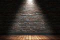 Dramatic stage lighting against brick wall and wooden floor backdrop