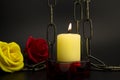 Burning yellow candle, chain and two roses Royalty Free Stock Photo
