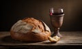 Dramatic still life of rustic bread, torn, and red wine in a chalice on a wooden table Royalty Free Stock Photo