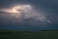 Dramatic storm cloud with lightning bolts curling around the top of the storm over the plains of North Dakota Royalty Free Stock Photo