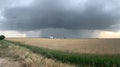 Dramatic storm clouds gather over golden fields and silos Royalty Free Stock Photo