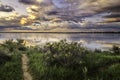 Dramatic Storm Clouds over a calm lake at sunrise Royalty Free Stock Photo