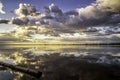 Dramatic Storm Clouds over a calm lake at sunrise Royalty Free Stock Photo