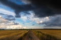 Dramatic storm clouds over fields. Country landscape. Windy weather. Plain field against the background of dark sky Royalty Free Stock Photo