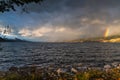 Dramatic storm clouds and rain passing over Okanagan Lake with view of a double rainbow above Naramata Royalty Free Stock Photo