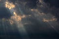 Dramatic storm clouds with rays of light passing through and lonely sea gull flying