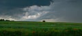 Dramatic storm clouds and sky from a strong thunderstorm in a summer field Royalty Free Stock Photo