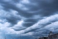 Dramatic Stormy Clouds over the High-Rise Rooftop with Cable Wires, TV Antennas and a Satellite Dish. Weather, Thunderstorm, Royalty Free Stock Photo