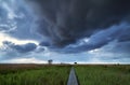 Dramatic stormy clouds over pier path