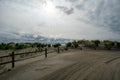 A Dramatic Stormy Sky Behind a Wooden Fence on the Beach Royalty Free Stock Photo