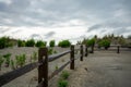 A Dramatic Stormy Sky Behind a Wooden Fence on the Beach Royalty Free Stock Photo