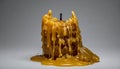 A dramatic studio shot capturing the intense melting process of a thick cylindrical candle featuring rich golden amber colored wax Royalty Free Stock Photo