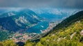 Dramatic summer cityscape of Kotor port. Aerial morning view of Kotor bay and  limestone cliffs of Mt. Lovcen. Sunny Adriatic seas Royalty Free Stock Photo
