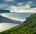 Dramatic summer morning in Dyrholaey Nature Reserve with view of black sund Reynisfjara beach. Great outdoor view of Reynisdranga Royalty Free Stock Photo