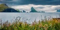 Dramatic summer panorama of Faroe Islands and Tindholmur cliffs on background Royalty Free Stock Photo