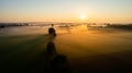 Dramatic summer sunrise. Panorama misty landscape. Foggy Morning over Green fields and meadows aerial view. Asphalt Royalty Free Stock Photo