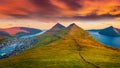 Dramatic summer sunset on Klaksvik town. Splendid evening view from populat tourist attraction - Klakkur peak, Faroe Islands